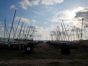 Ship moored at harbor against sky
