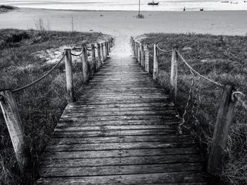 Empty wooden footbridge leading to beach