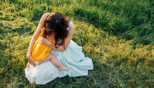 Young woman sitting on field