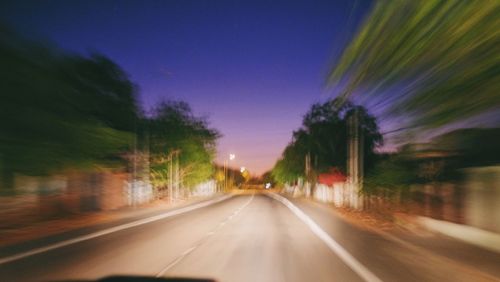 Road passing through illuminated tunnel