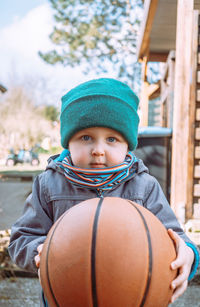 Portrait of boy playing basketball