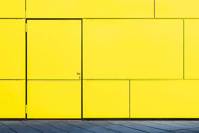 Yellow closed door of building in city