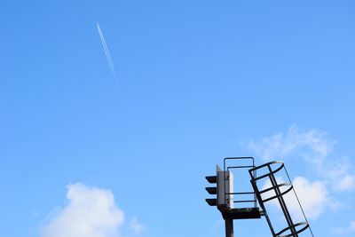 Low angle view of security camera against blue sky