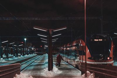 Train on railroad station platform at night