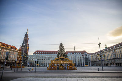 Sculpture of buildings against cloudy sky