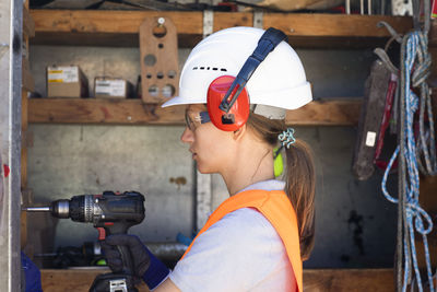 Young woman working in a workshop as artisan manual worker