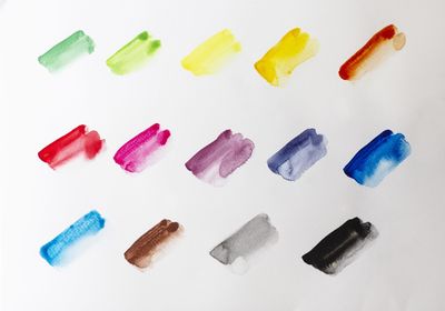 High angle view of colored pencils over white background