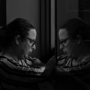 Woman reflecting on mirror