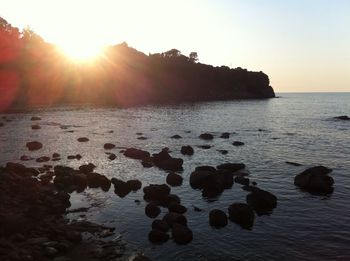 Scenic view of sea against clear sky at sunset