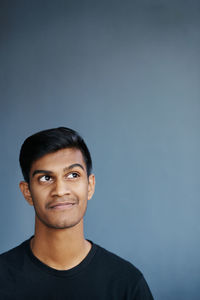 Portrait of young man against clear sky