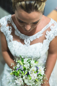 High angle view of beautiful bride holding flower bouquet