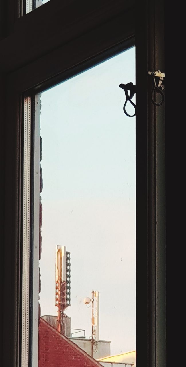 LOW ANGLE VIEW OF BUILDING SEEN THROUGH WINDOW