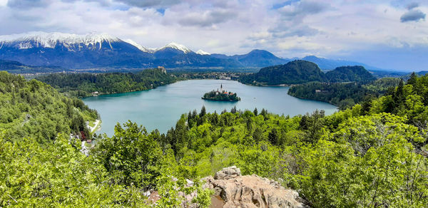 Scenic view of trees and mountains against sky