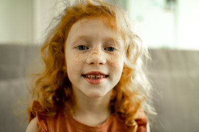 Smiling redhead girl with freckles