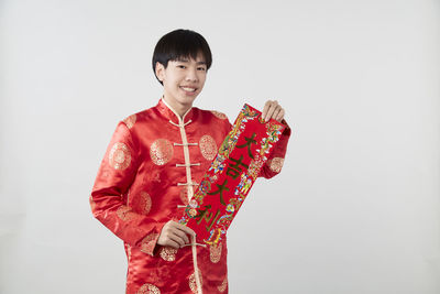 Portrait of a smiling young man against white background