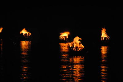 Reflection of illuminated fire in water at night