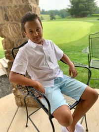 Portrait of boy sitting on seat