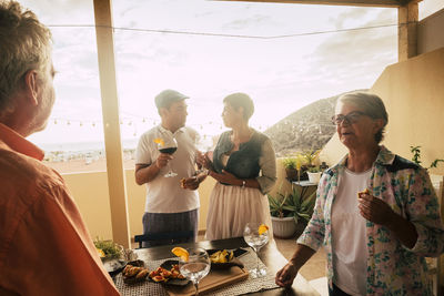 People enjoying at restaurant against sky