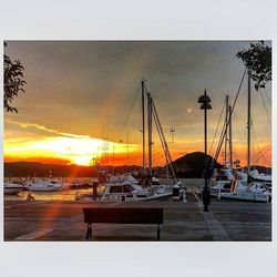 Sailboat in sea at sunset