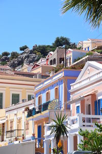 Houses in town against blue sky