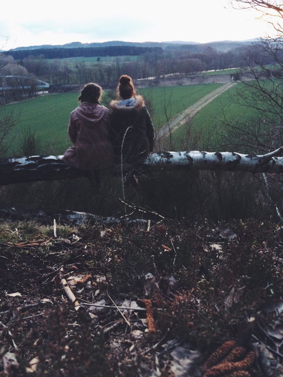 landscape, field, lifestyles, rural scene, leisure activity, grass, mountain, nature, sitting, tranquility, tranquil scene, agriculture, rear view, farm, men, casual clothing, full length, sky