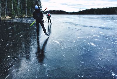 Full length of person walking on frozen lake