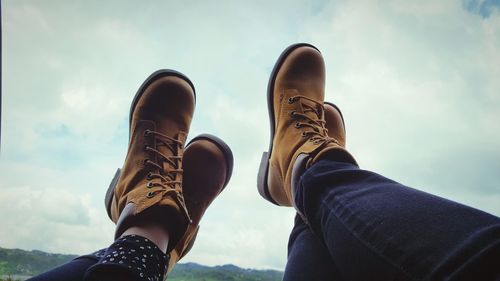 Close-up of people with their feet up