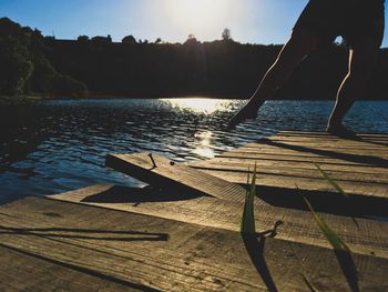 Scenic view of swimming pool by sea against sky during sunset