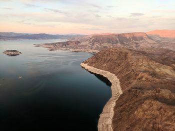 Scenic view of river against sky during sunset