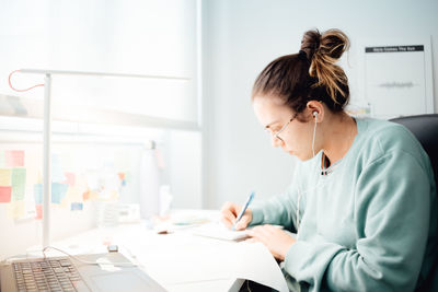 Side view of doctor working at office