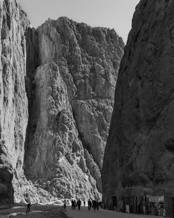 People walking on rocky canyon