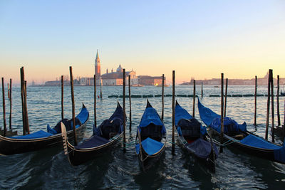 Panoramic view of wooden posts in canal against sky