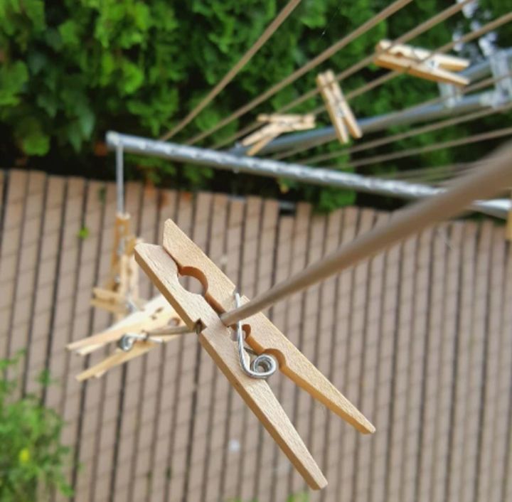 metal, focus on foreground, no people, clothespin, clothesline, day, close-up, selective focus, hanging, outdoors, nature, wood - material, railing, laundry, brown, fence, architecture, plant, barrier, absence, iron