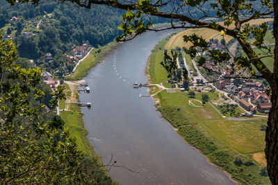 High angle view of river amidst trees and buildings