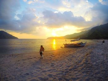 Scenic view of beach against sky during sunset