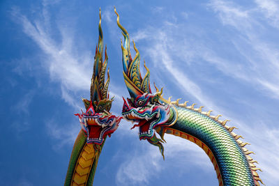 Low angle view of sculpture against blue sky