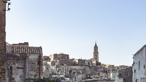 View of buildings in city against clear sky