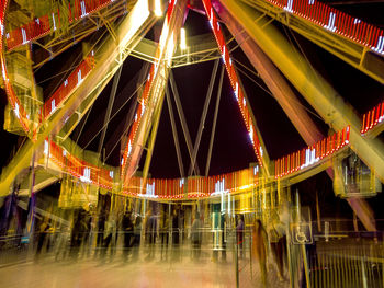 Illuminated ferris wheel in city at night