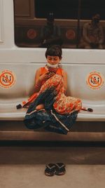 Cute girl sitting on floor at home