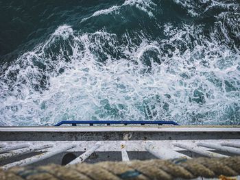 High angle view of waves splashing on shore
