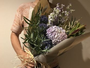 Close-up of hand holding flower bouquet