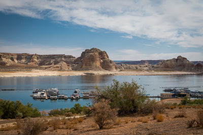 Panorama of boats on lake powell, arizona with low water level.