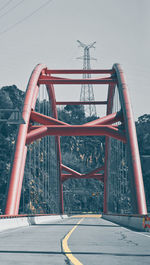 Bridge over river in city against sky