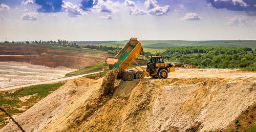 Bulldozer at construction site against sky