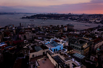 High angle view of city at seaside during sunset