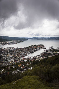 High angle view of buildings by sea against sky