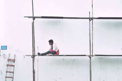 Man working at construction site against building