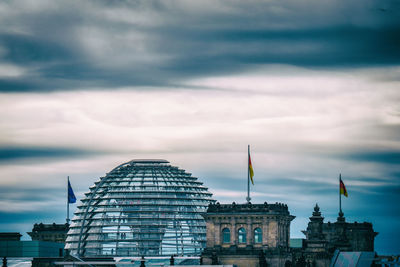 People walking in the reichstag dome in berlin with dense clouds
