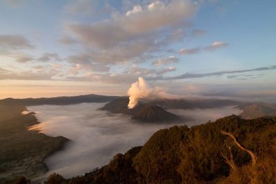 View of volcanic landscape against cloudy sky