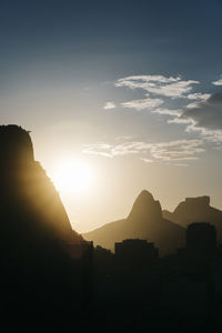 Scenic view of silhouette mountains against sky during sunset